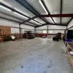 Spacious metal barn with equipment.